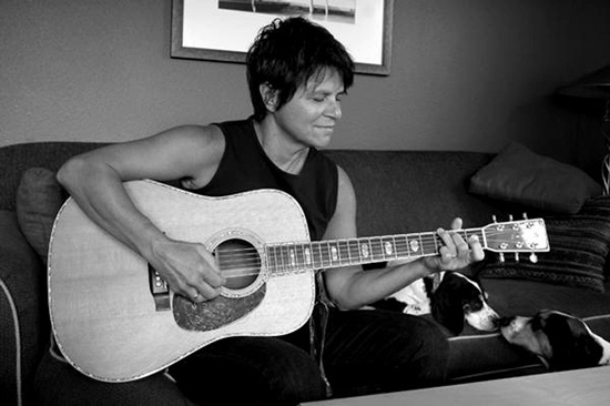 Tret Fure playing the guitar and singing